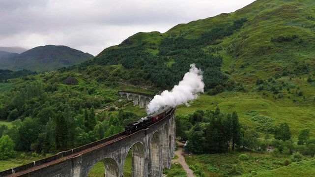 Jacobite Steam Train Crossing Glenfinnan Viaduct in Scottish Highlands