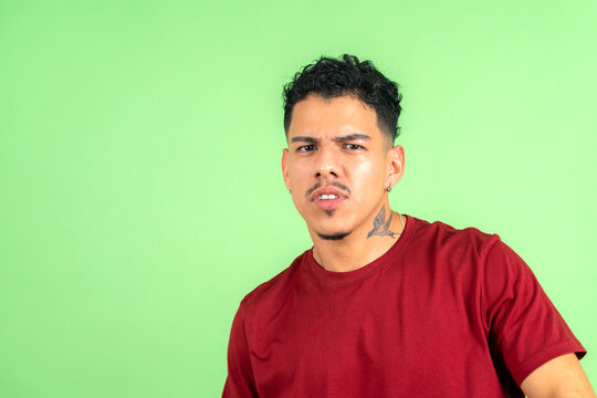Young adult man expressing confusion and doubt