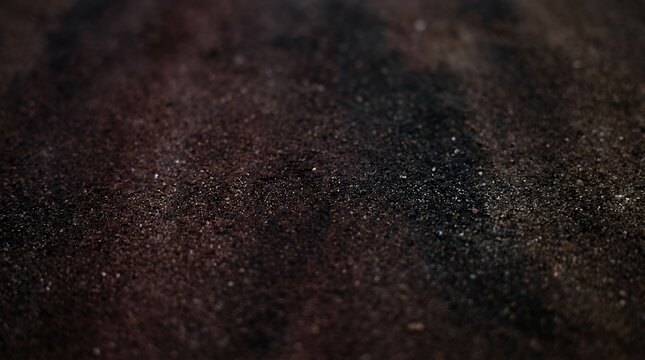 Somber maroon and black sandy blend non figurative backdrop speckle color transition non representational setting for internet header flyer layout sand surface finish empty zone canvas background