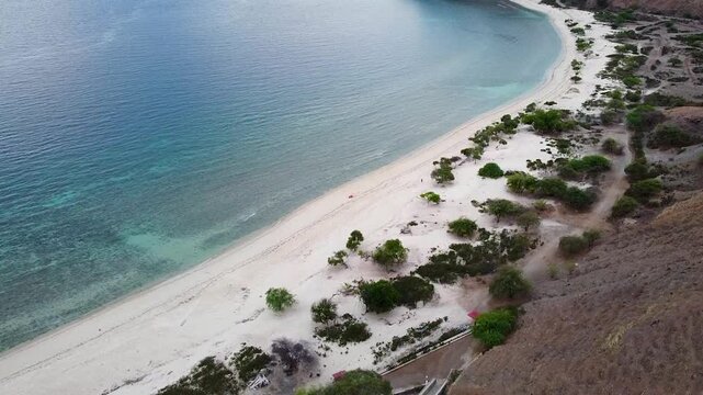 Aerial view rising above idyllic white sand beach with mangroves and crystal clear turquoise ocean water in Dili, Timor-Leste, Southeast Asia