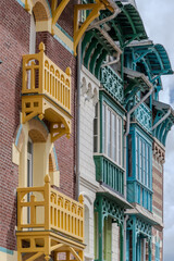 Fototapeta premium Houses of Mers-les-Bains, seaside town with 19th-century sea-bathing villas with colorful wooden balconies and white chalk cliffs, tourists destination in France