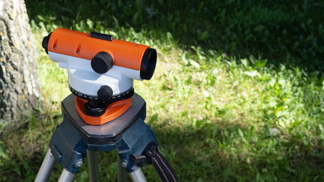 Geodetic surveying. An optical leveling instrument mounted on a tripod is used for measuring ground elevations and height differences during construction and land surveying.
