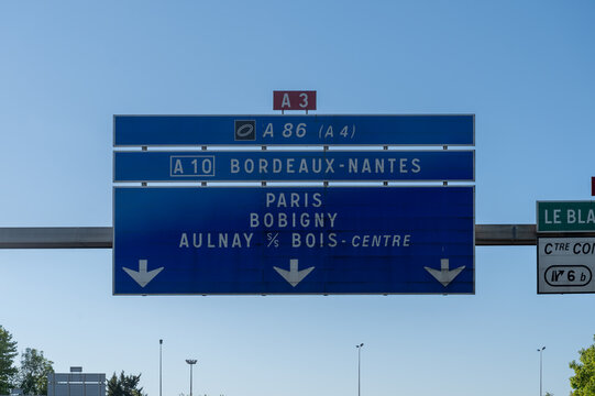 View of a French and European autoroute with overhead directional signs pointing to major cities like Paris, Bordeaux, Lille, Calais, showing lanes, traffic and motorway infrastructure, road signes