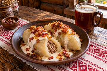 Lithuanian cepelinai potato dumplings with sour cream and bacon © Henrik
