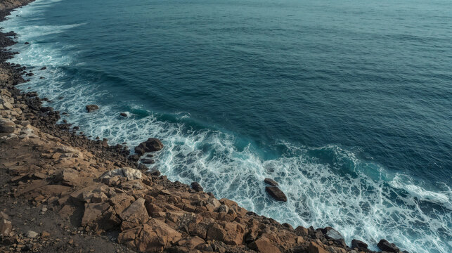 Mediterranean bay with rolling waves and curved rocky shoreline