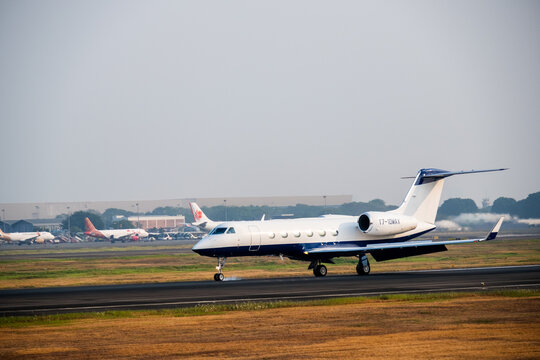 Tangerang, Indonesia - August 25, 2026: Gulfstream G450 private jet lands on the runway at Soekarno-Hatta International Airport.