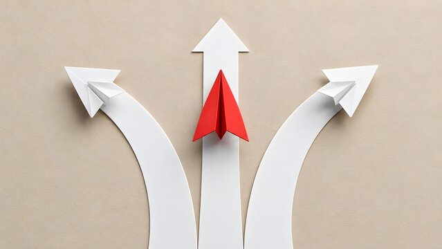 Red origami paper plane flying straight ahead while white planes turn away representing business leadership and making strategic choices