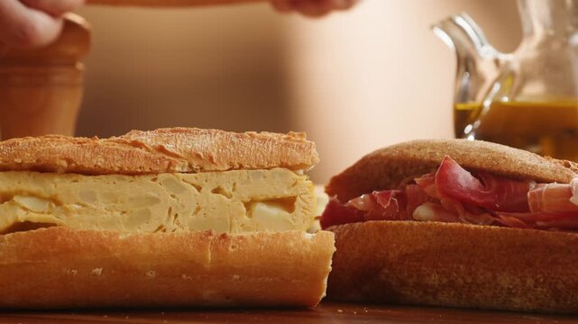 Sandwich assortment of Spanish bocadillos with jamon serrano, tortilla omelette and tomato mozzarella in crusty baguette, close up food for cafe breakfast menu
