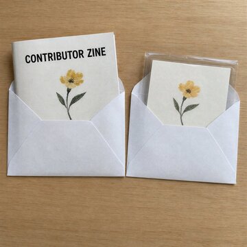 Top View of Contributor Zine and Floral Card in Open Envelopes