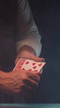 Magic trick, Professional croupier shuffling and dealing playing cards at a casino table, poker and blackjack game, magician performing a card trick shuffling cards deck