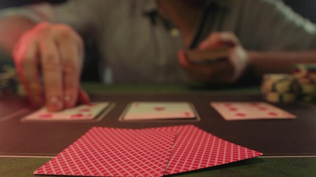 Casino player, Game of poker in casino, taking place with poker chips and cards on a green table betting chips, gambling place, roulette jack pot. All in bet game. 