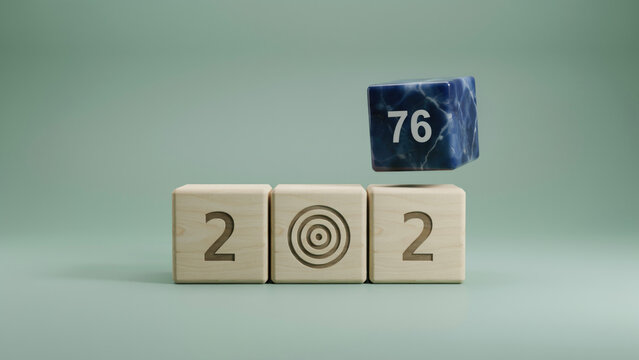 Wooden cubes displaying the number 202 with a target symbol and a floating blue cube with 76 with while blue marble textured cube marked 76 hovers above third block