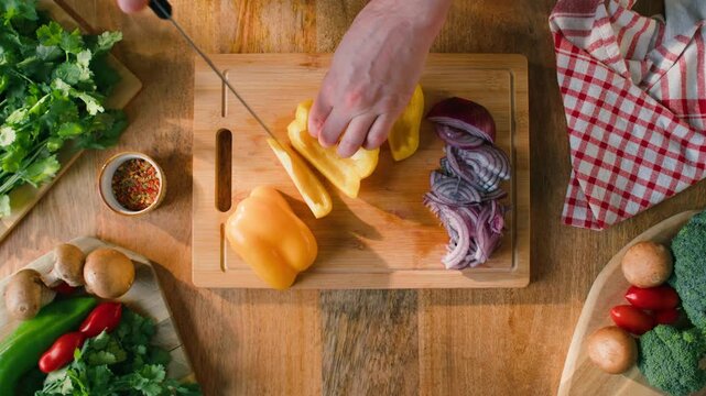 Man cut yellow sweet pepper, Healthy food, Chef hands with knife for onion, cutting and preparation with cooking for dish. Restaurant, culinary service and cook with skills for catering