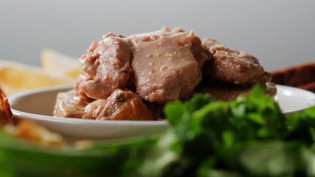 Cod liver superfood can, omega 3 Smoked cod liver in oil in open tin can with fresh greens on wooden table. Seafoods delicacy