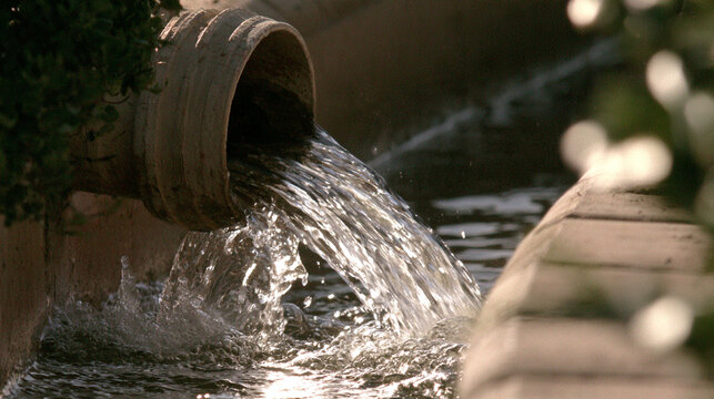 Fresh Clean Water Flowing From Metal Pipe Into Green Grass Channel
Water Flowing From Metallic Pipe Line Into Dry Ground Dirt Trench


