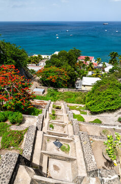 View looking terraced concrete drainage channel of Claes Gut toward Lower Town and the Caribbean Sea in Oranjestad, Sint Eustatius, Caribbean Netherlands.