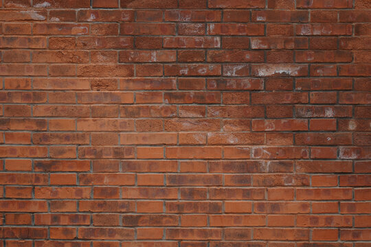 Close-up view of an old brick wall with visible texture and color variations