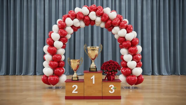 Gold trophies and red roses sit on a podium under a red and white heart balloon arch on stage. Perfect for love competition awards.