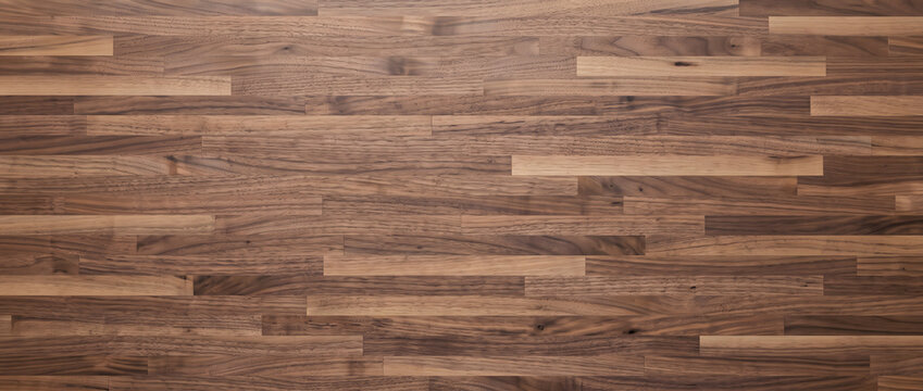 Rich walnut plank flooring texture with contrasting light and dark grain for a warm hardwood interior background