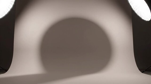 Photography studio setup with white backdrop and professional lighting equipment for commercial production shoot