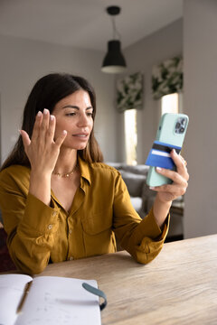Woman holding smartphone and card feeling stressed due to declined credit card, insufficient funds in bank account, unexpected charges. Financial concerns, payment failure, or failed money transfer