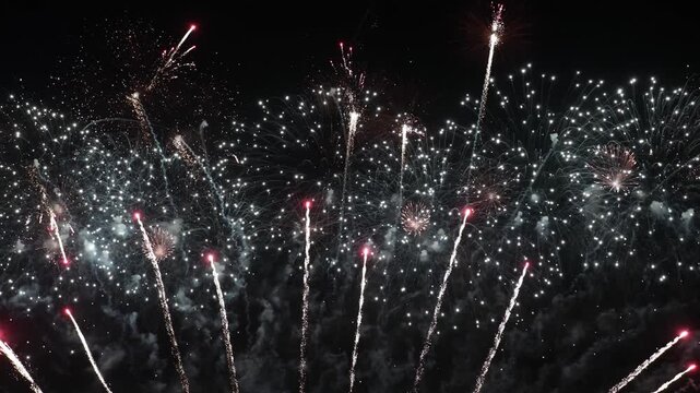 Spectacular aerial fireworks display exploding in night sky, a brilliant celebration of light and color.