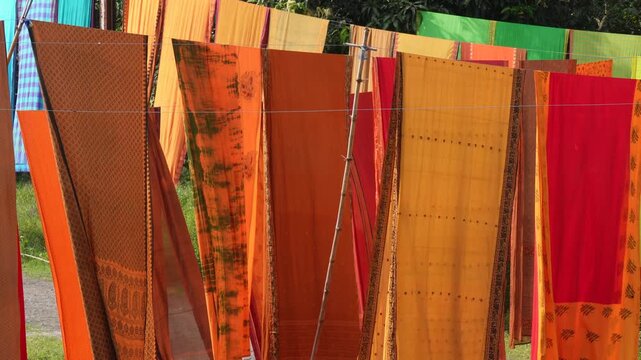 Bright dyed fabrics drying in the sunlight