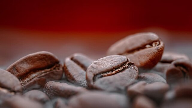 Roasted coffee beans releasing aromatic steam in cinematic macro video footage.