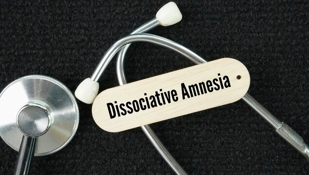 Stethoscope and stick with words Dissociative amnesia is a mental health condition where a person cannot remember important personal or autobiographical information