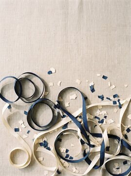 Paper confetti and streamers on terracotta background with copy space