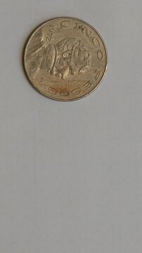Finger Holding Vintage 1972 Five Pesos Mexican Coin