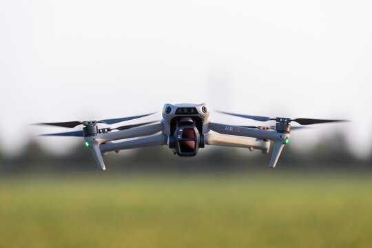 Poznan, Poland, 03 October 2026; DJI Air 3S Camera Drone Hovering Above a Field in Warm Sunlight with Copy Space