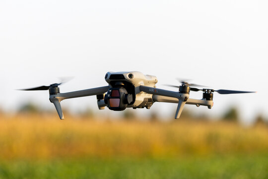 Poznan, Poland, 03 October 2026; DJI Air 3S Camera Drone Hovering Above a Field in Warm Sunlight with Copy Space
