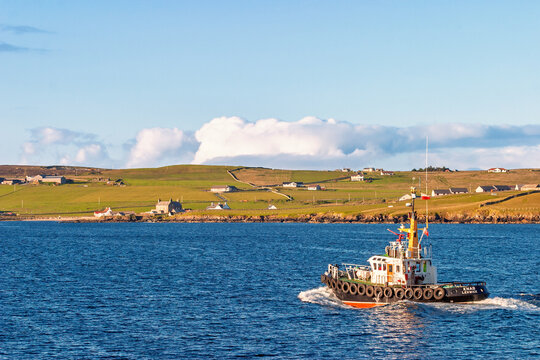 Tugboat sailing along the Shetland coast