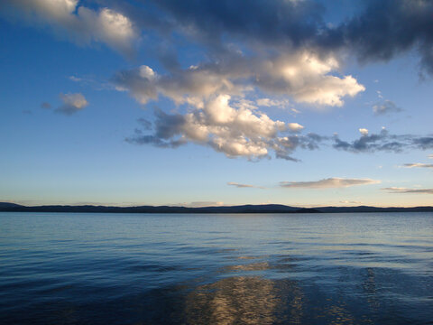 Serene Lake Scene with Cloudy Sky and Calm Water