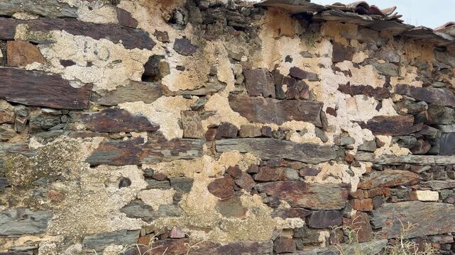 Patones traditional slate stone wall of a rustic house in spain