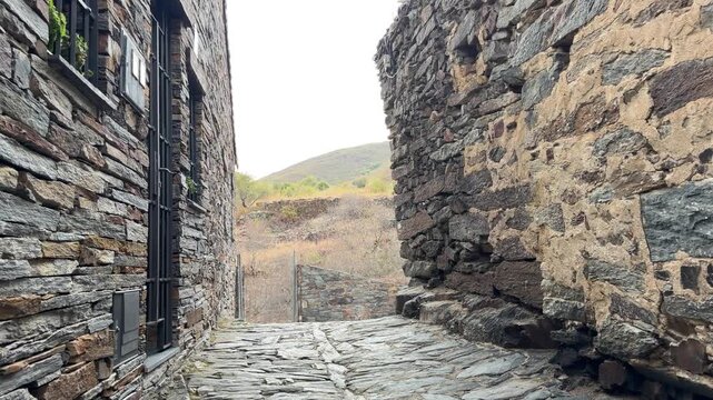Patones walking down a narrow stone street in patones, spain