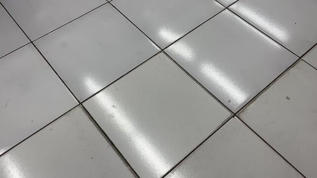 Close up of clean porcelain tiled floor with light reflection