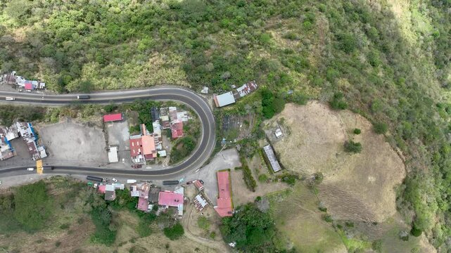 Heavy Truck Traffic on Winding Mountain Highway at Alto de La Mona in Guaduas, Colombia. Establishing Shot. Aerial View.