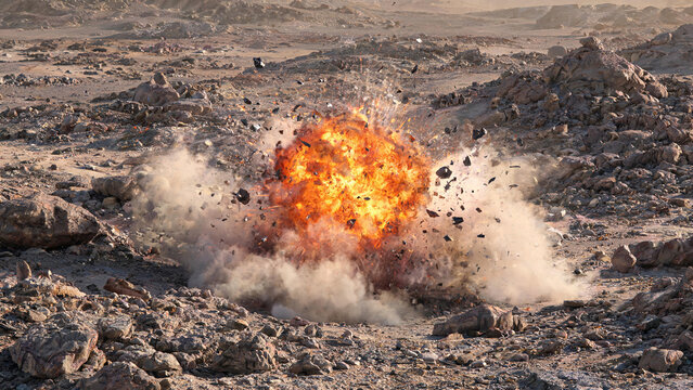 A fiery explosion erupts on rocky arid desert ground, sending debris and dust scattering outward.