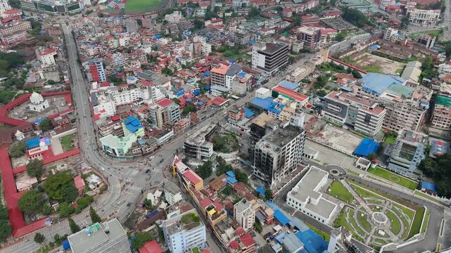 Wide drone shot of roads and urban settlement in Kathmandu valley.