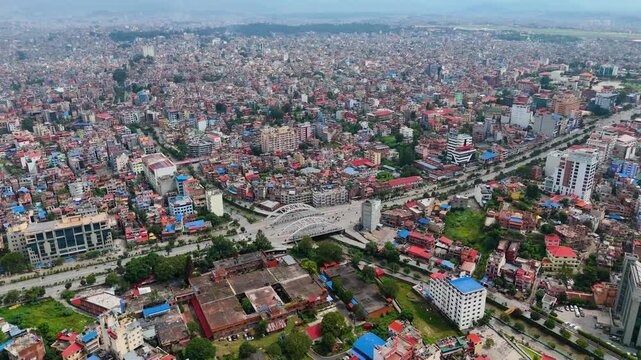 Wide drone shot of roads and urban settlement in Kathmandu valley.