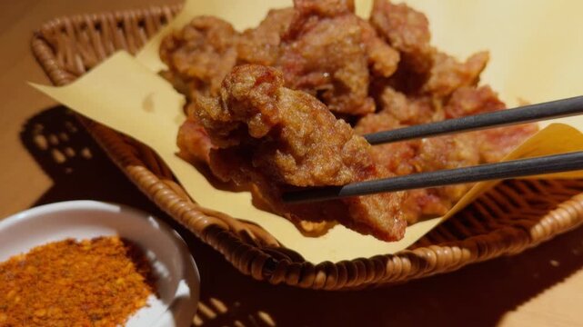 Qingdao Chinese Fried Pork Pieces Lifted by Chopsticks Close-Up Street Food