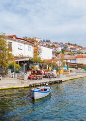 Fototapeta premium Quiet lakeside terrace with a moored boat in Ohrid old town