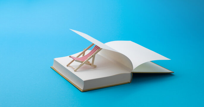 Wide Angle Summer Reading Concept with Open Book and Deck Chair
