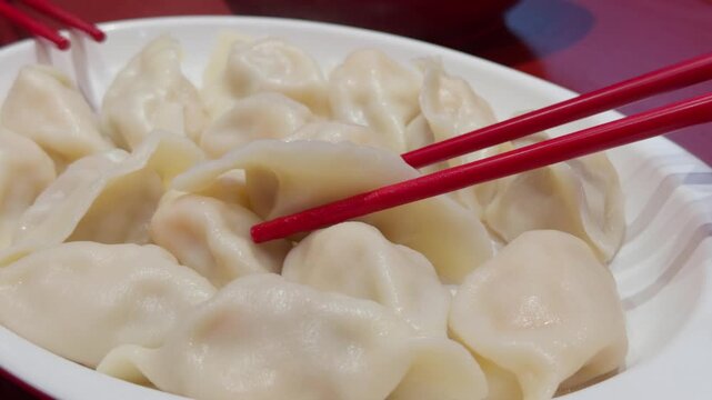 Steaming Hot Chinese Dumpling Jiaozi Lifted by Chopsticks Close-Up Qingdao