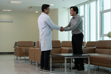 Doctor greeting patient with handshake during medical consultation in hospital waiting room © Stock Media Labs