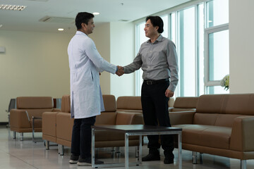 Doctor greeting patient with handshake during medical consultation in clinic waiting room © Stock Media Labs