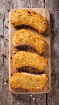 Breaded taco shells on wooden board