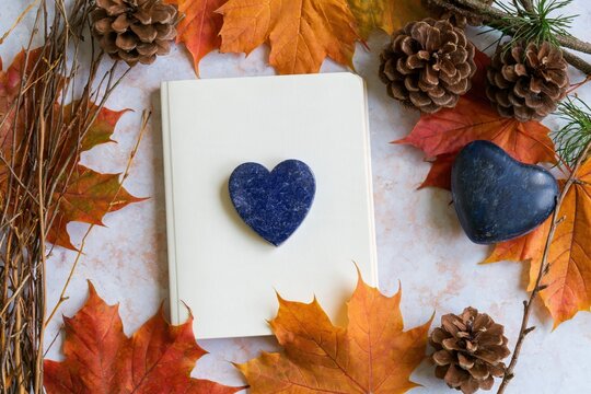 Autumn arrangement with notebook and heart stones